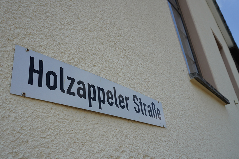 Straßenschild der Holzappeler Straße an einem Gebäude in Charlottenberg, Rhein-Lahn-Kreis.